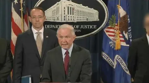 Attorney General Jeff Sessions, with Deputy Attorney General Rod Rosenstein behind him, announces the AlphaBay takedown at the Justice Department