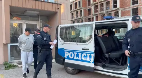 Do Kwon, handcuffed, walked out of a police station in Podgorica after his arrest