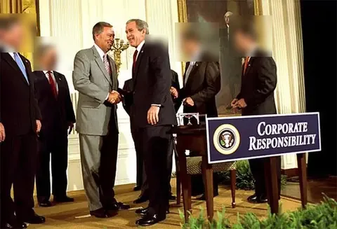 President Bush shakes hands with Congressman Mike Oxley at the signing of the Sarbanes-Oxley Act