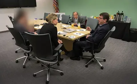 Elizabeth Holmes with Deputy Defense Secretary Ash Carter (right) and former Defense Secretary William Perry (centre back) at Theranos, Palo Alto, 17 April 2013