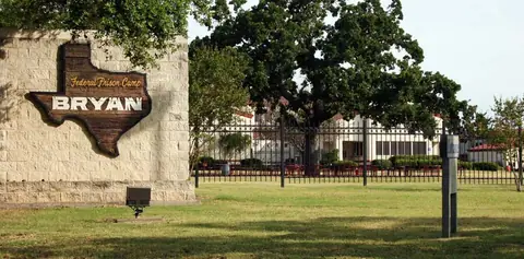 The gate of Federal Prison Camp Bryan, where Holmes is serving her sentence