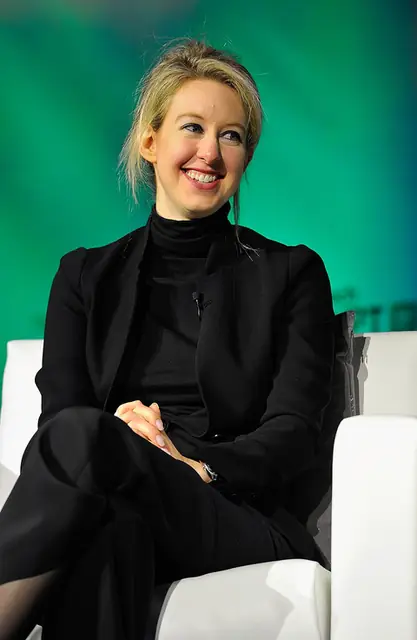 Holmes, in the black turtleneck, on stage at TechCrunch Disrupt, San Francisco, 8 September 2014