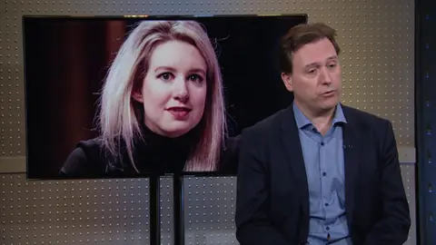 Carreyrou on CNBC's Mad Money on the publication of Bad Blood, with Holmes on the studio screen