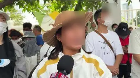 Depositors gather outside the National Bank of Cambodia asking for help withdrawing money still trapped in Huione Pay
