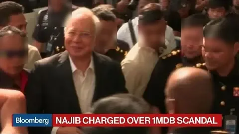 Najib Razak arrives at the Kuala Lumpur court complex to be charged with criminal breach of trust and abuse of power, the day after his arrest