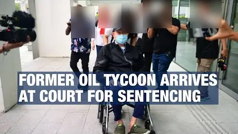 Lim, 82, is wheeled into the State Courts for his sentencing hearing