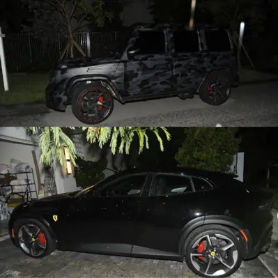 A camouflage-wrapped Mercedes G-Wagon and a black Ferrari Purosangue outside the raided house