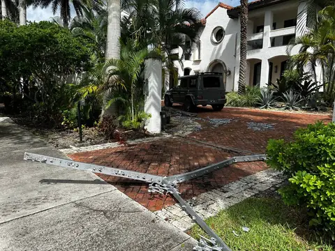 The morning after the FBI raid: the front gate of the rented mansion at 1201 NE 83rd Street lies flattened on the driveway